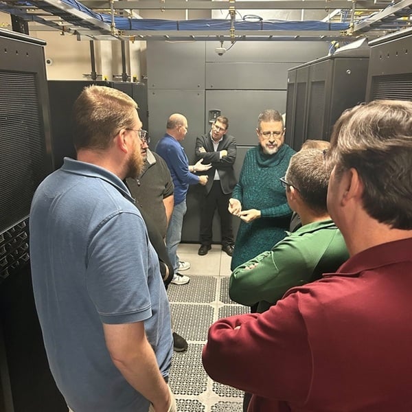 Nysernet Chief Network Architect Bill Owens speaks with members in the Syracuse Data Center
