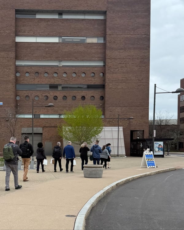 people walking across a campus