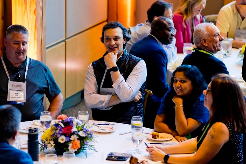 Nysernet members in conversation around a  NYSCIO conference table.