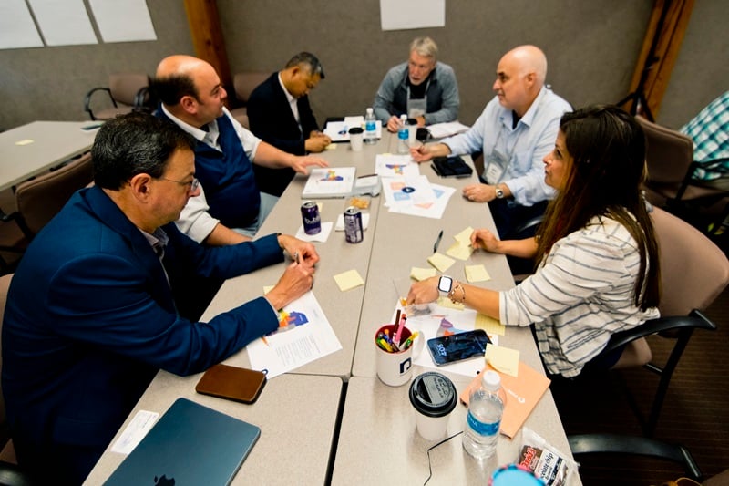 Nysernet members gather around a work table to discuss services and solutions.