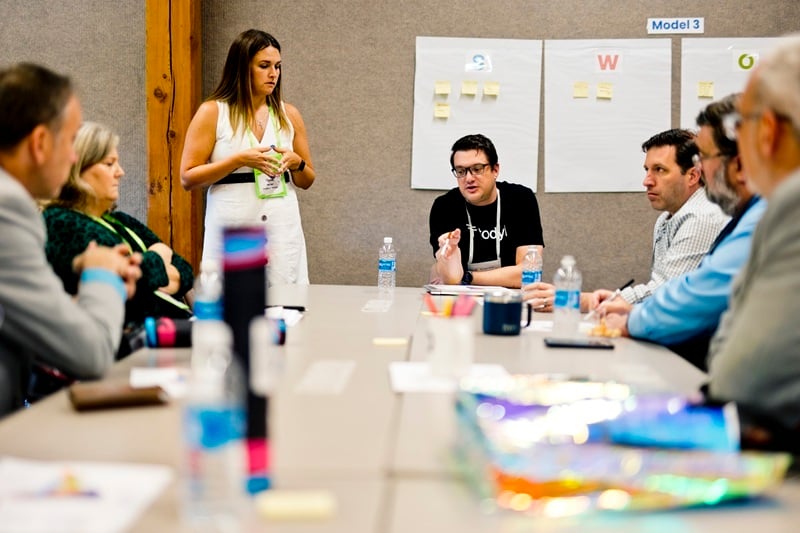 Nysernet members sit around a table in discussion over services.