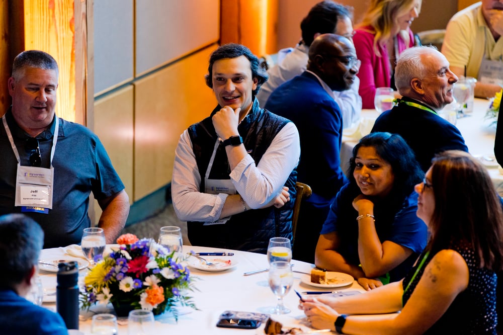 Nysernet members in conversation around a  NYSCIO conference table.