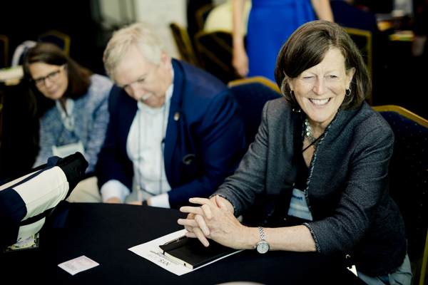 3 individuals around a conference table